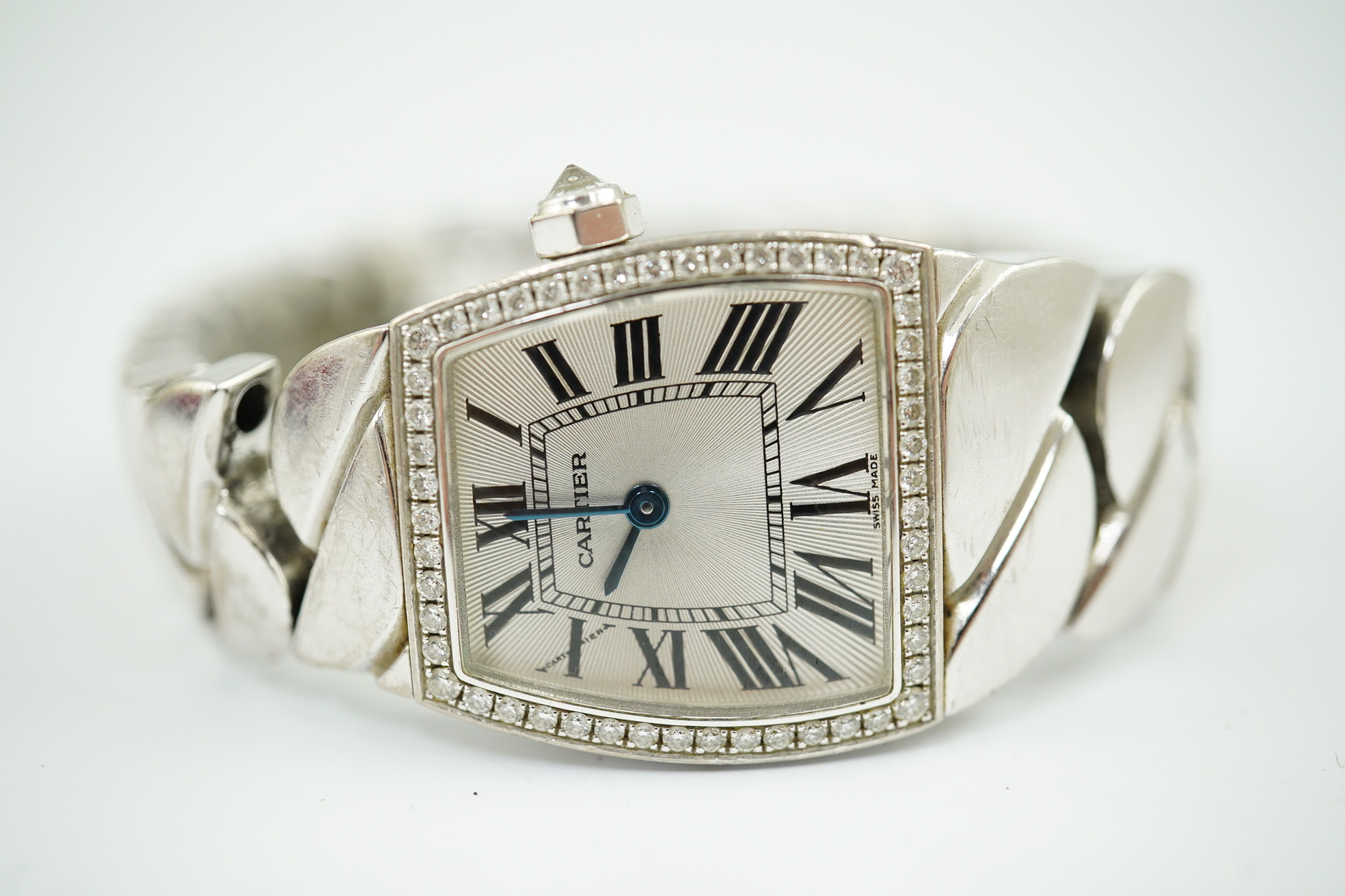 A lady's recent 18ct white gold and diamond set Cartier La Dona quartz wrist watch, on an 18ct white gold Cartier bracelet